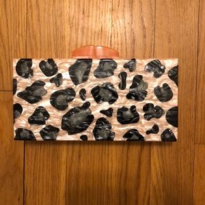 Tuckernuck leopard resin clutch with strap.